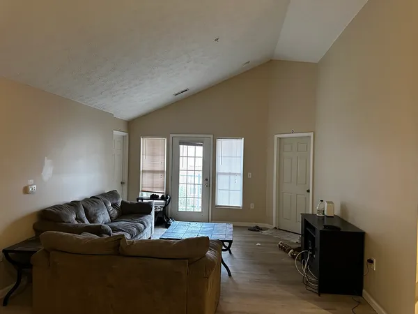 a living room with furniture window and a flat screen tv