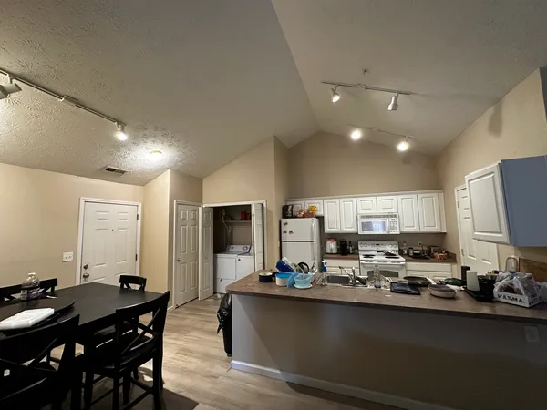 a kitchen with kitchen island granite countertop a sink counter top space and stainless steel appliances