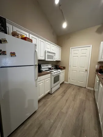 a white refrigerator freezer sitting inside of a kitchen