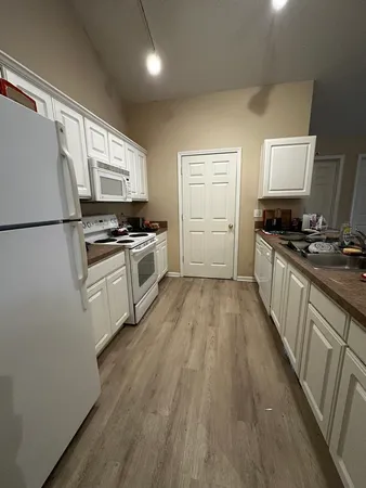 a kitchen with a stove a sink and a refrigerator
