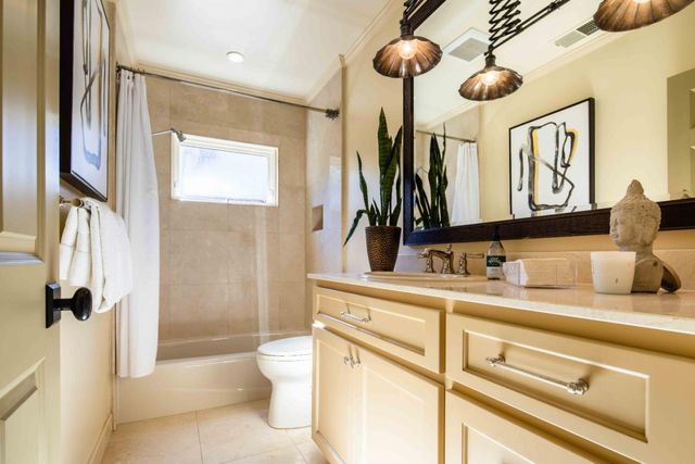 a spacious bedroom with a bed and wooden floor