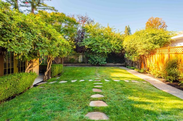 a living room with furniture a rug and a chandelier