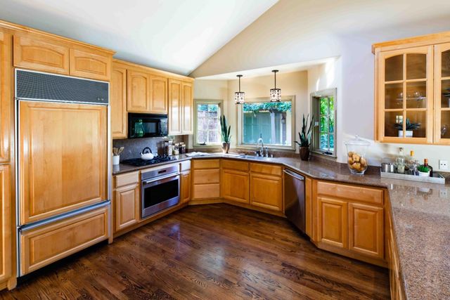 a living room with fireplace furniture and a potted plant