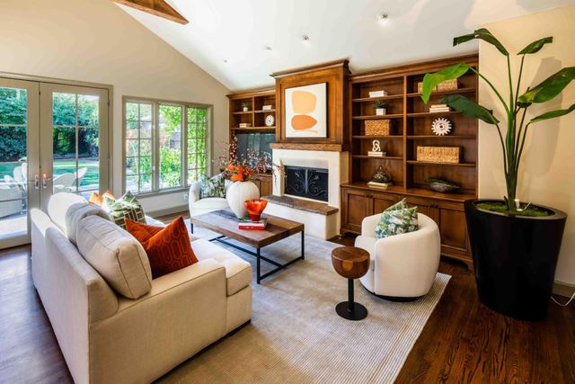 a hallway view with wooden floor and windows
