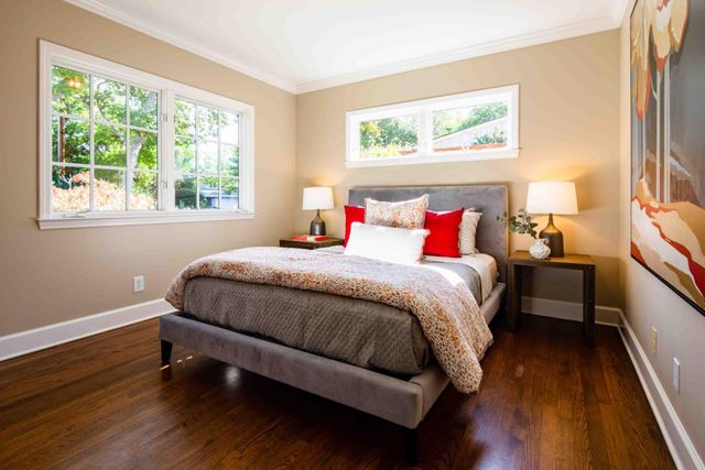 a bedroom with bed and a window