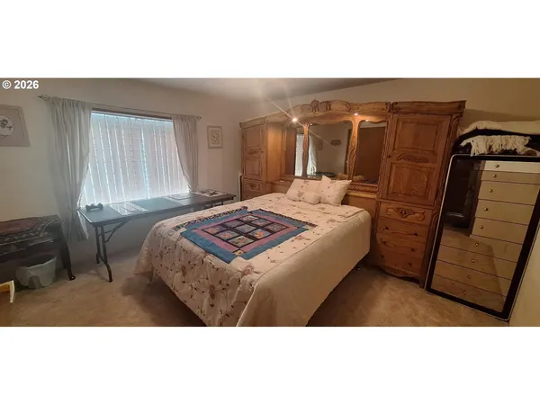 a bedroom with a bed and a mirror