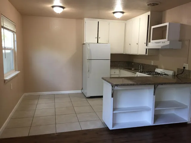 a kitchen with a sink cabinets and microwave