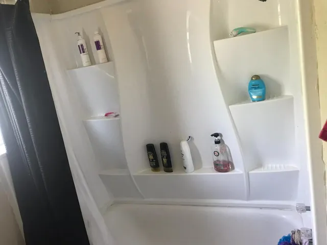 a bathroom with a bathtub and shower