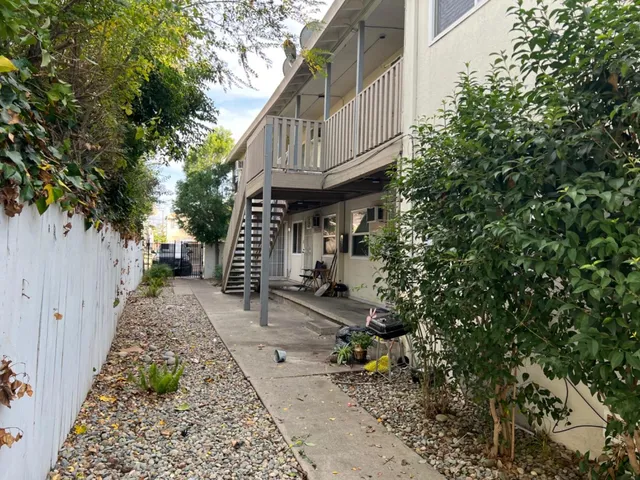 a view of a pathway of a house with sitting area