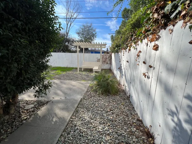 a view of a pathway of a house with a yard