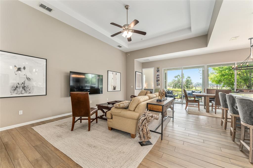 4958 Northwest 35th Ln Road Ocala, FL 34482 - Photo 17 of 66 a living room with furniture a large window and a dining table