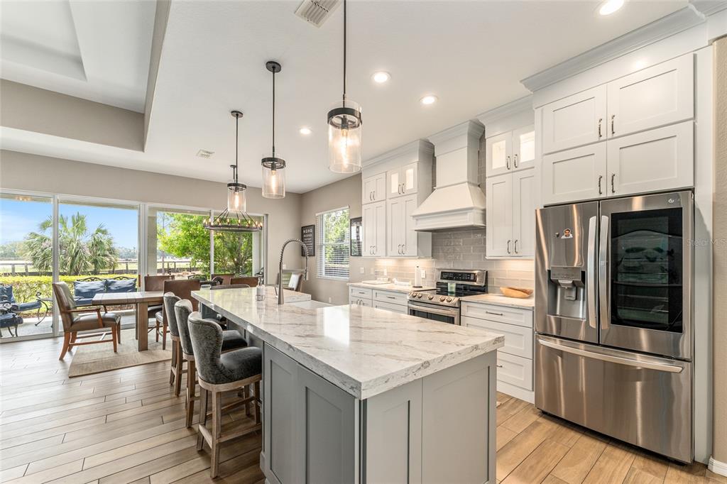 4958 Northwest 35th Ln Road Ocala, FL 34482 - Photo 31 of 66 a kitchen with stainless steel appliances granite countertop a stove and a refrigerator