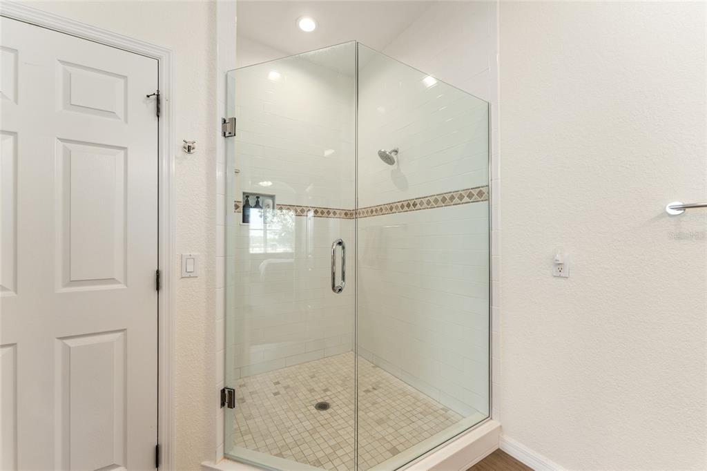 4958 Northwest 35th Ln Road Ocala, FL 34482 - Photo 40 of 66 a bathroom with a glass shower door