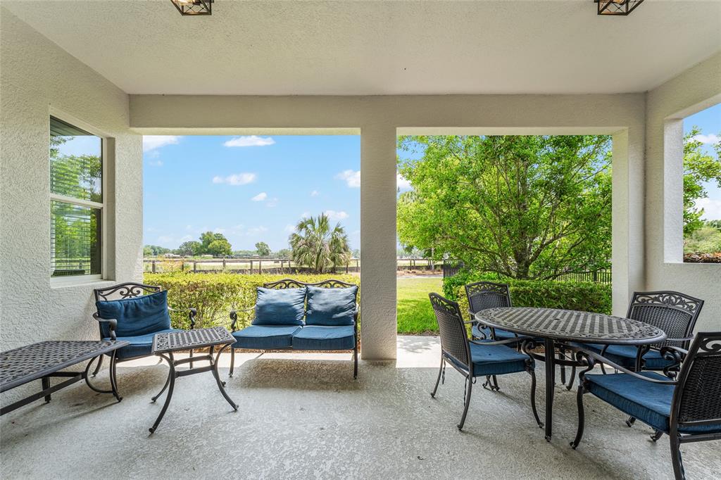 4958 Northwest 35th Ln Road Ocala, FL 34482 - Photo 54 of 66 a living room with patio furniture and a floor to ceiling window