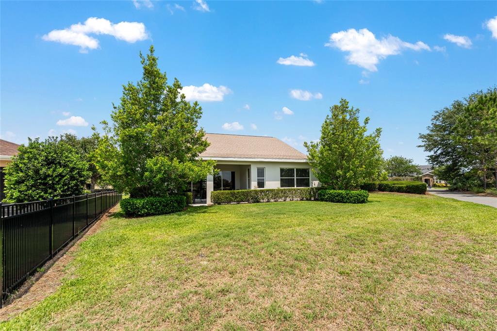 4958 Northwest 35th Ln Road Ocala, FL 34482 - Photo 60 of 66 a backyard of a house with table and chairs