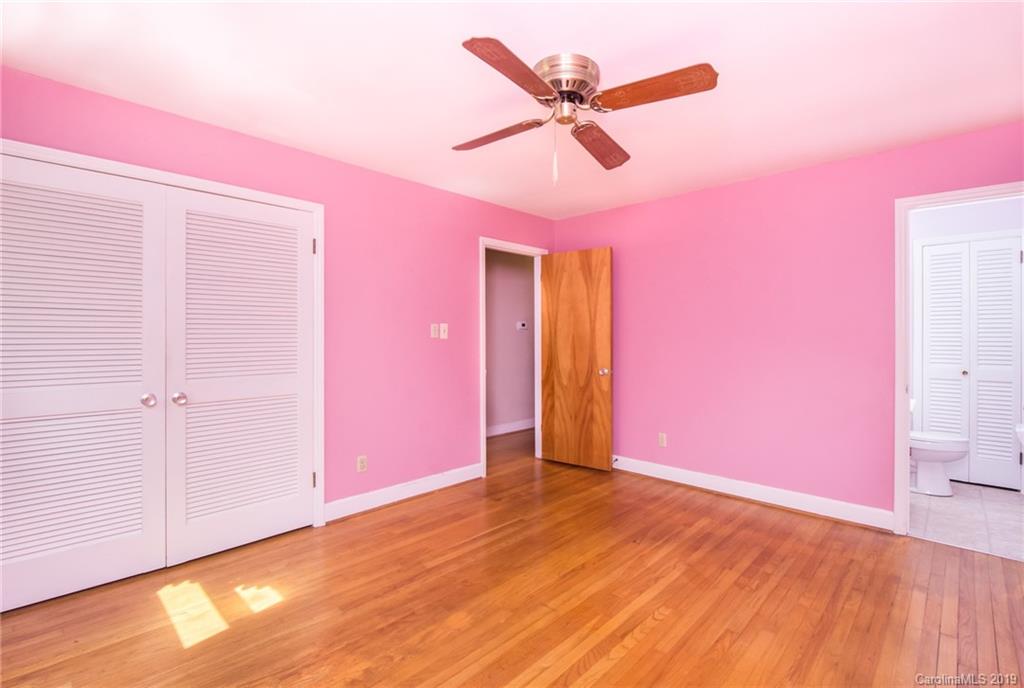7225 Watercrest Road Charlotte, NC 28210 - Photo 14 of 32 a view of a livingroom with wooden floor and a ceiling fan