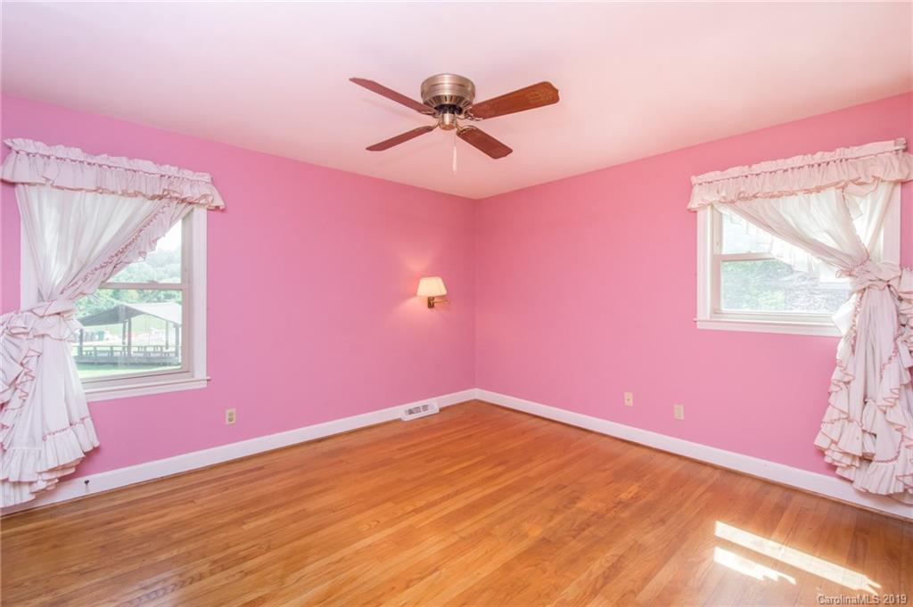 7225 Watercrest Road Charlotte, NC 28210 - Photo 15 of 32 a view of a livingroom with hardwood floor and a ceiling fan