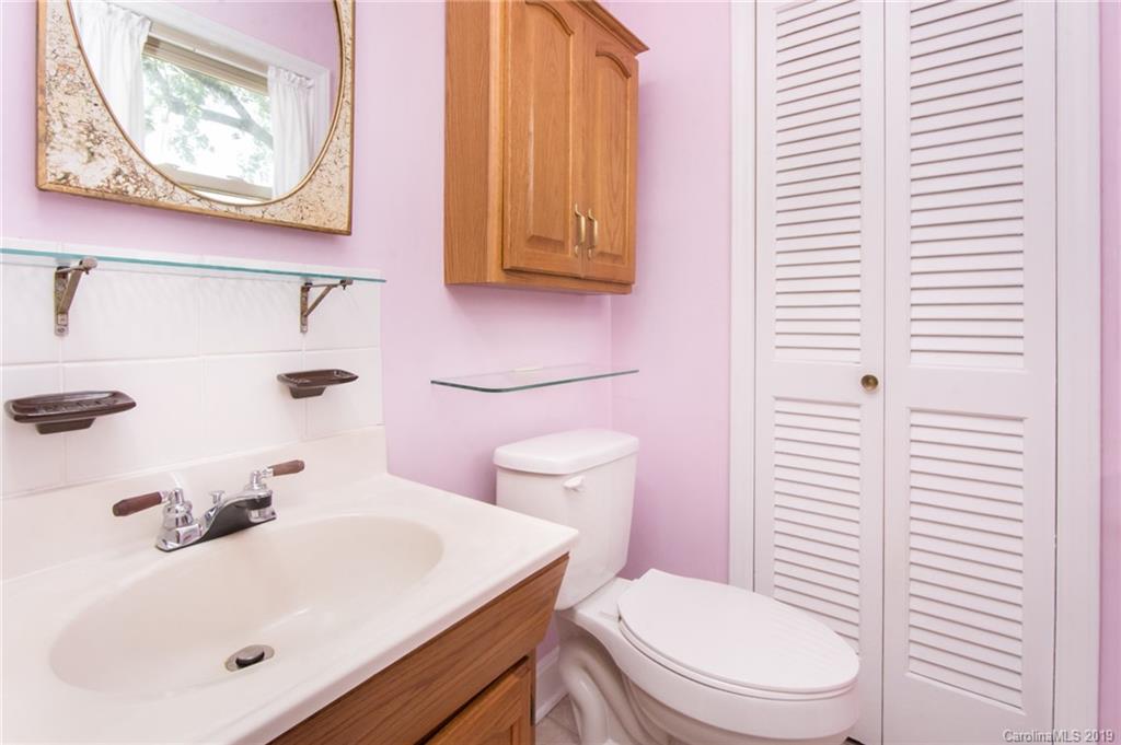 7225 Watercrest Road Charlotte, NC 28210 - Photo 16 of 32 a bathroom with a sink a toilet and a mirror
