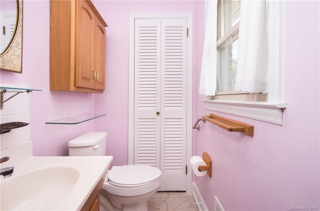 7225 Watercrest Road Charlotte, NC 28210 - Photo 17 of 32 a bathroom with a toilet a sink and a window