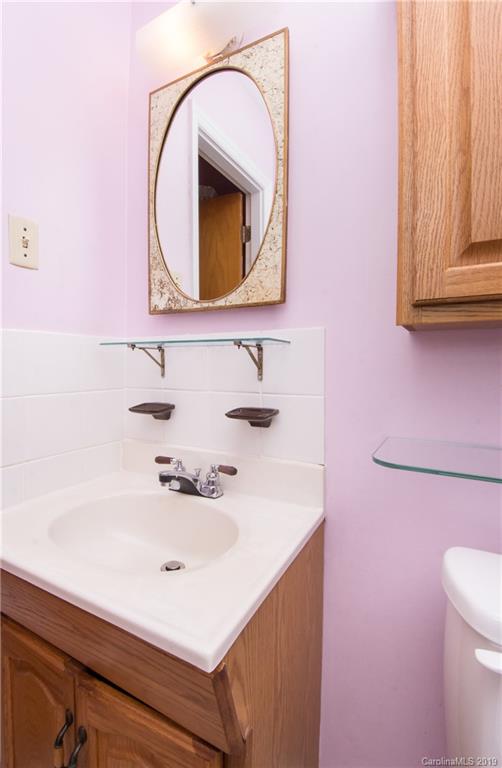 7225 Watercrest Road Charlotte, NC 28210 - Photo 18 of 32 a bathroom with a sink a vanity and a mirror