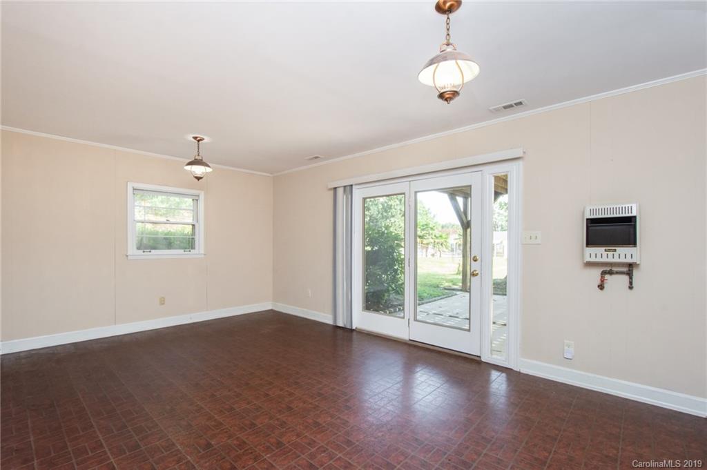 7225 Watercrest Road Charlotte, NC 28210 - Photo 19 of 32 a view of an empty room with wooden floor and a window