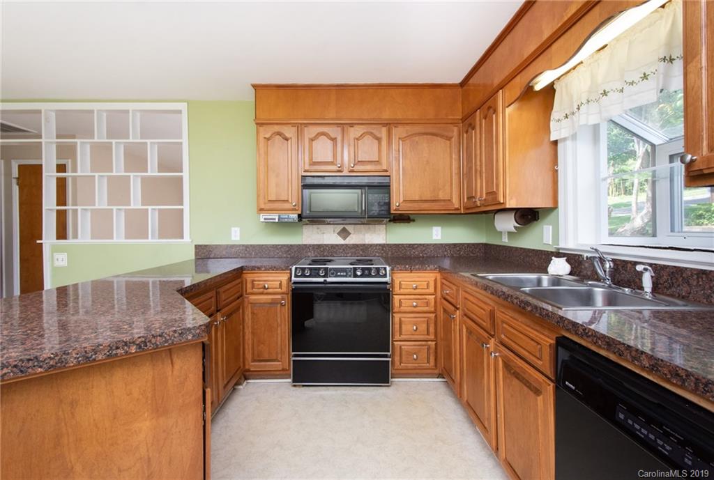 7225 Watercrest Road Charlotte, NC 28210 - Photo 6 of 32 a kitchen with stainless steel appliances granite countertop a stove a sink and a granite counter tops