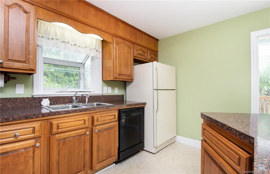 7225 Watercrest Road Charlotte, NC 28210 - Photo 7 of 32 a kitchen with a sink a refrigerator and a window