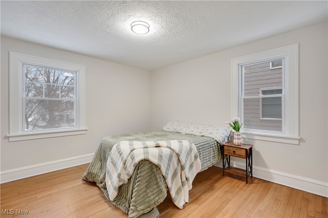 2016 Rossmoor Road Cleveland Heights, OH 44118 - Photo 24 of 46 Bedroom with a textured ceiling and light wood-style floors