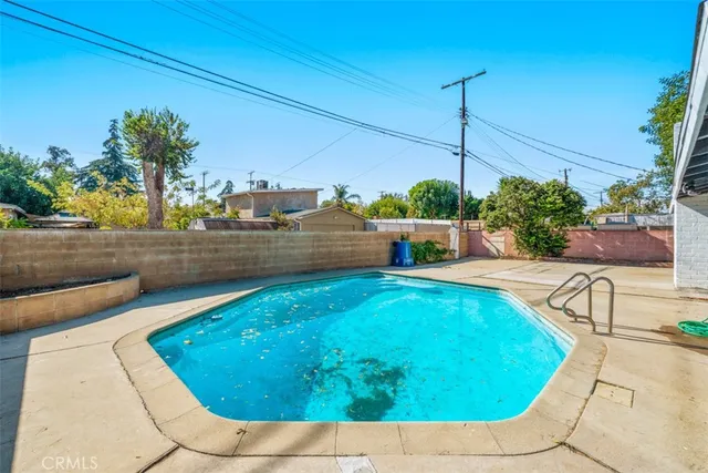 a view of a swimming pool with a yard