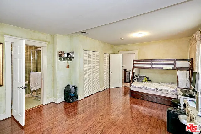 a bedroom with furniture and a wooden floor