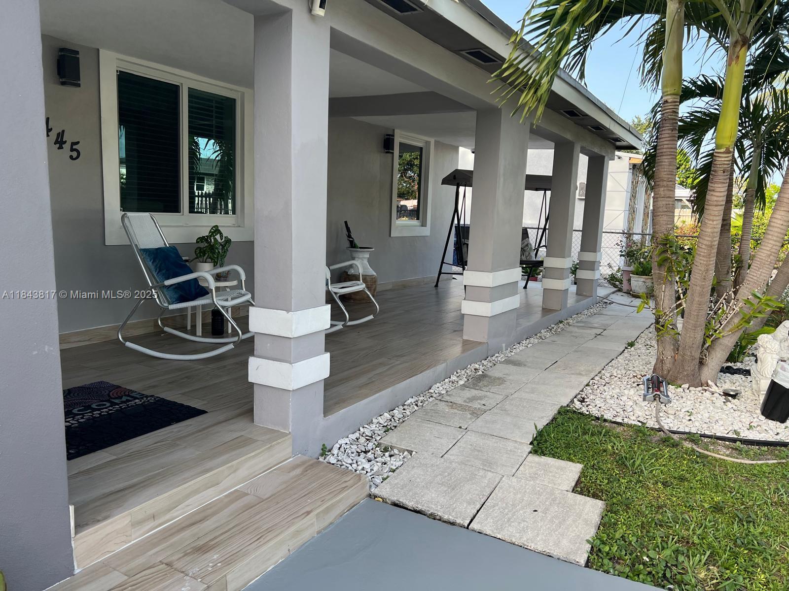 a view of a patio with couches table and chairs and potted plants