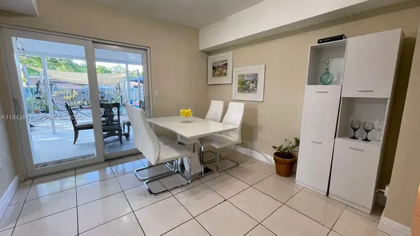 a kitchen with stainless steel appliances kitchen island granite countertop a refrigerator and a sink
