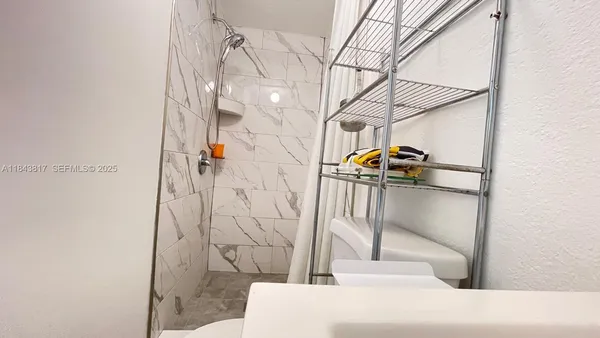 a kitchen with stainless steel appliances cabinets and a window