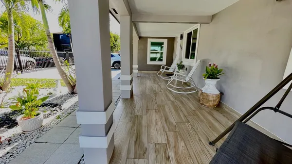 a view of a dining room with furniture a potted plant