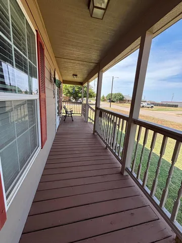 a view of balcony with wooden floor