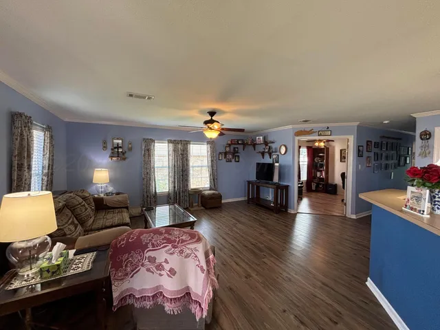 a living room with furniture and wooden floor