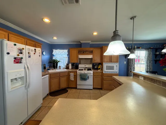 a kitchen with refrigerator a sink and cabinets