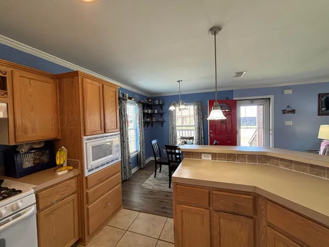 a kitchen with a refrigerator a stove and a window