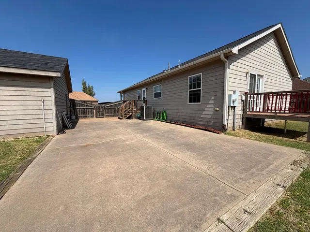 a view of a house with a backyard and a garage