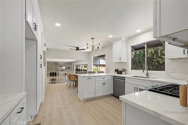 a kitchen with a sink a stove and cabinets