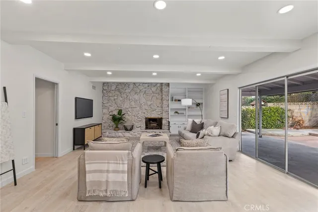 a living room with fireplace furniture and a flat screen tv