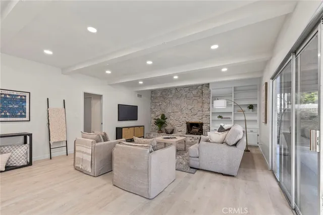 a living room with fireplace furniture and a flat screen tv
