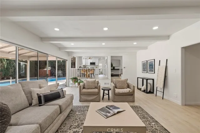 a living room with furniture a rug and a large window
