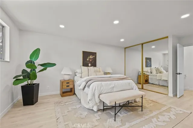 a bed room with a bed and a potted plant