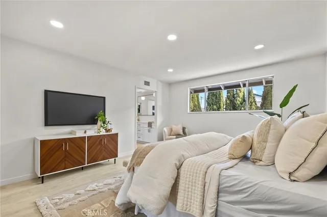 a bedroom with a bed and a flat screen tv