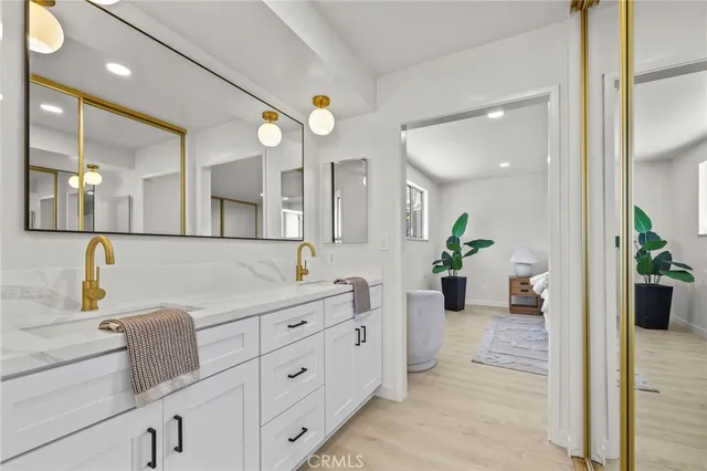 a spacious bathroom with a granite countertop sink a mirror and a