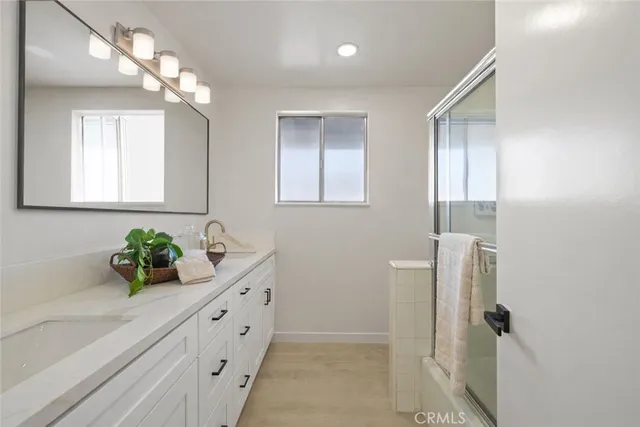 a bathroom with a double vanity sink and a mirror