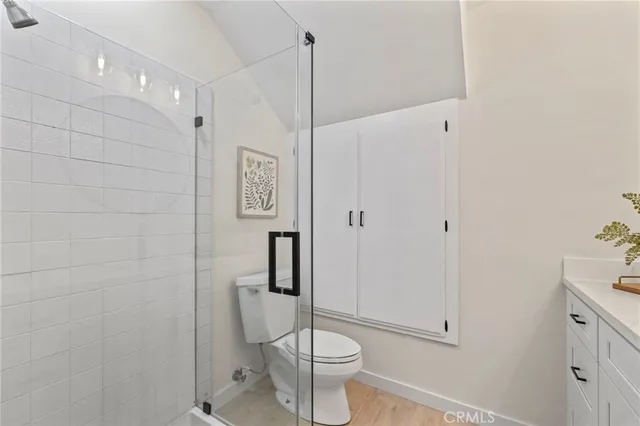 a bathroom with a toilet and a shower
