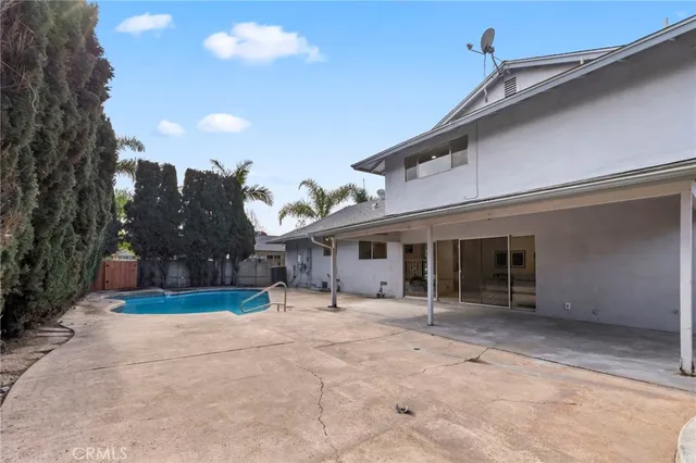 a view of a house with a big yard and large trees
