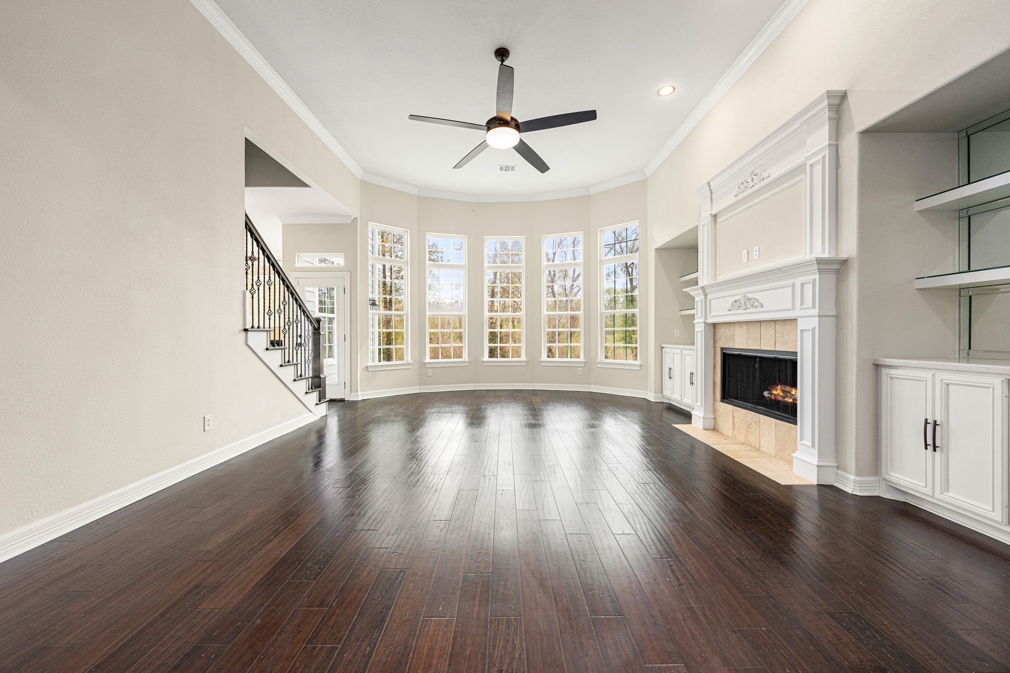 14882 Gingham Road Montgomery, TX 77356 - Photo 14 of 50 an empty room with wooden floor fireplace and windows